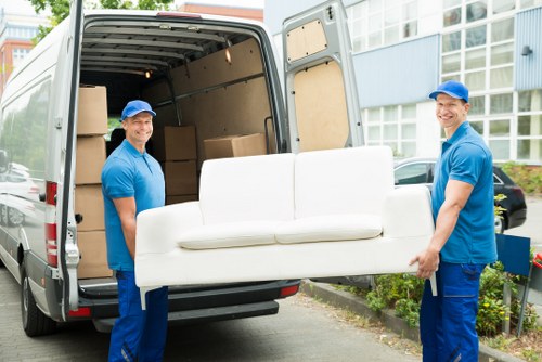 Moving team using safe handling procedures during a van loading job
