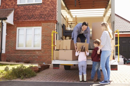 Professional movers loading boxes into a removal van in Sidcup